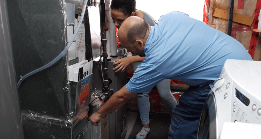 Technician inspecting heating equipment.