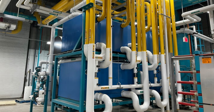 Interior shot of Maple Leaf Foods Heritage Facility in Hannon, Ontario, with energy infrastructure and pipes along walls and ceiling.