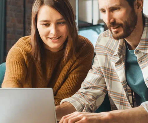 Two people looking at computer at work
