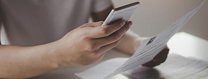 Showing hands of a person using mobile smart phone for scan and payment online
