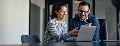 Two people looking at computer