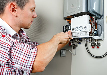 Plumber repairing a gas boiler