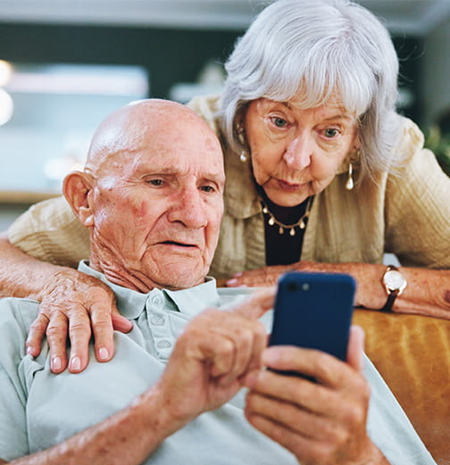Elderly woman, man and smartphone 