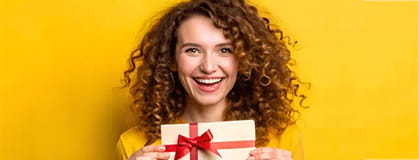 Happy woman holding a gift card