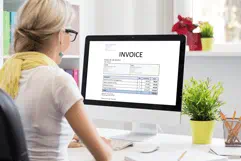 Lady looking at invoice on computer