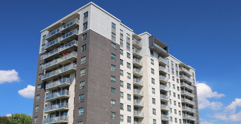Exterior of large grey condominium