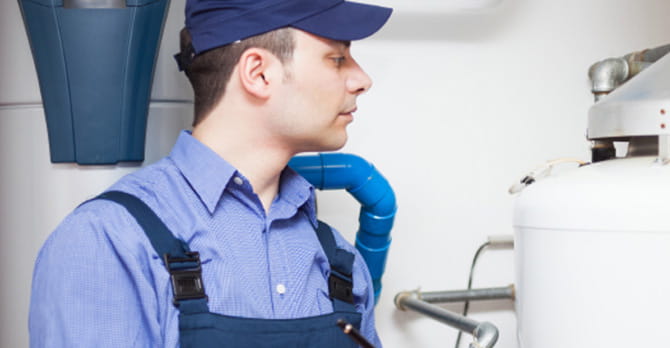 Man examines hot water heater