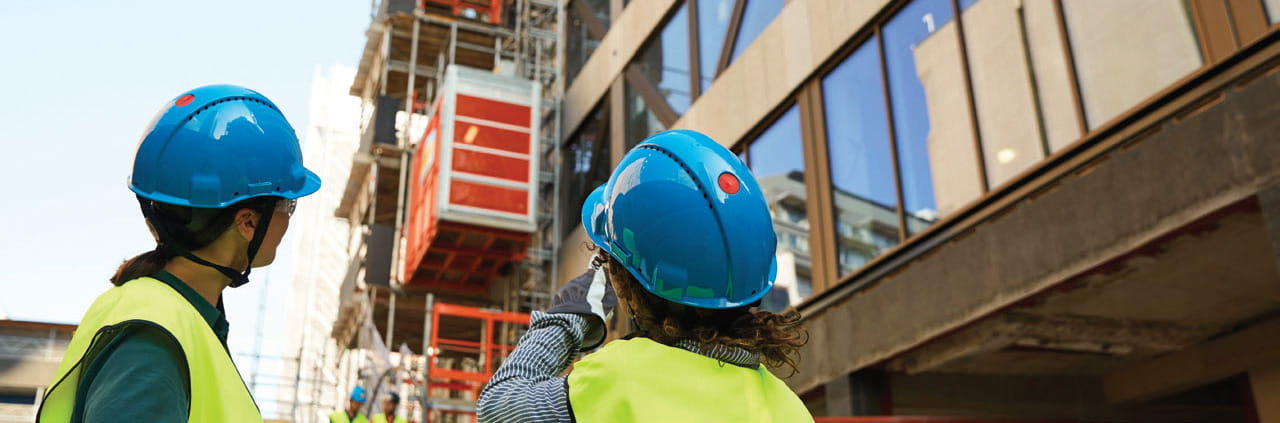 Workers looking at a buiilding