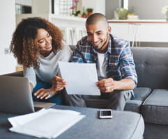A couple in front of a laptop