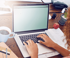 Hands and laptop in home on a website.